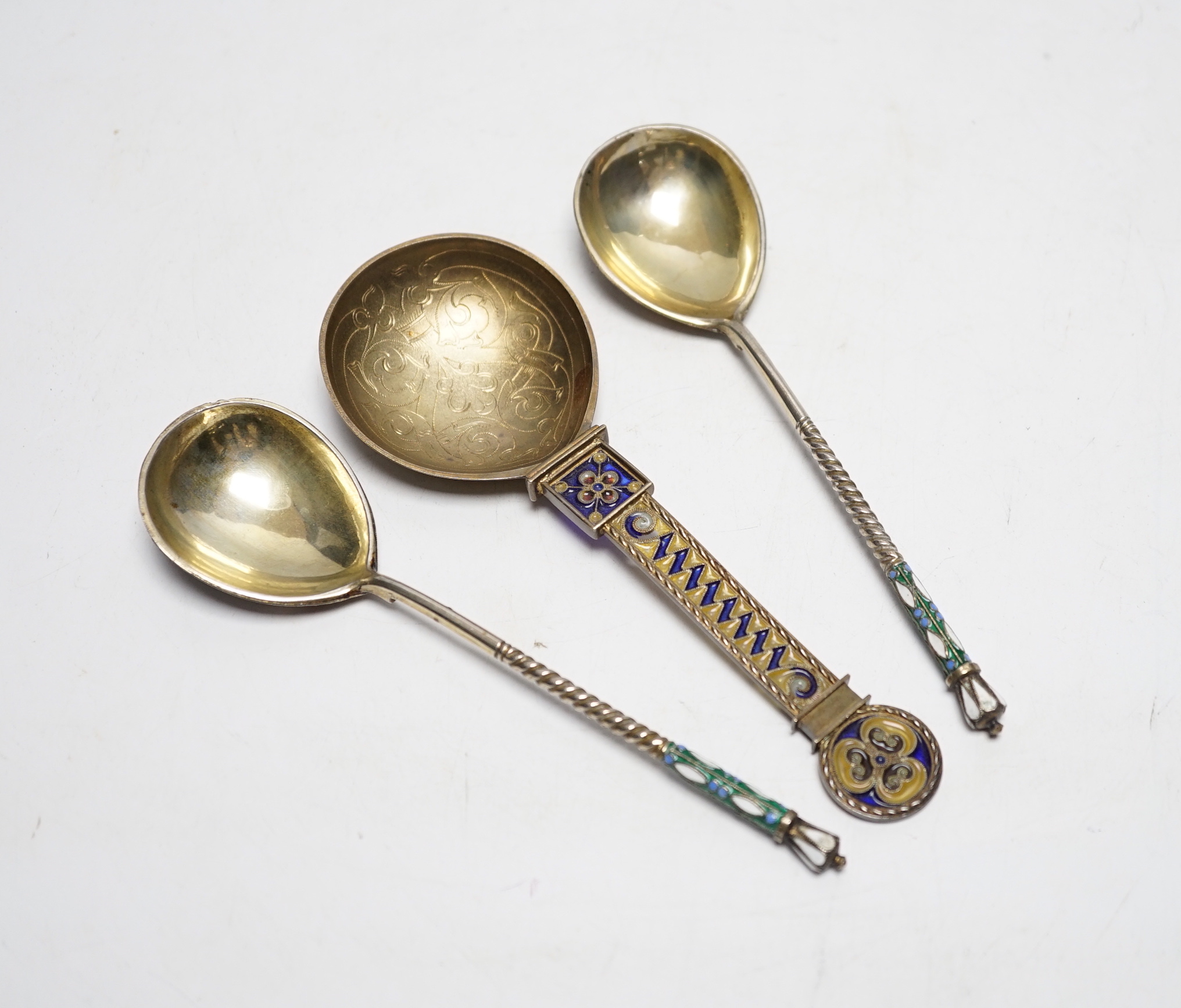 A Norwegian gilt sterling and plique a jour enamelled spoon, 16.2cm (a.f.), together with a pair of late 19th/early 20th century Russian 84 gilt zolotnik and cloisonné enamel spoons.